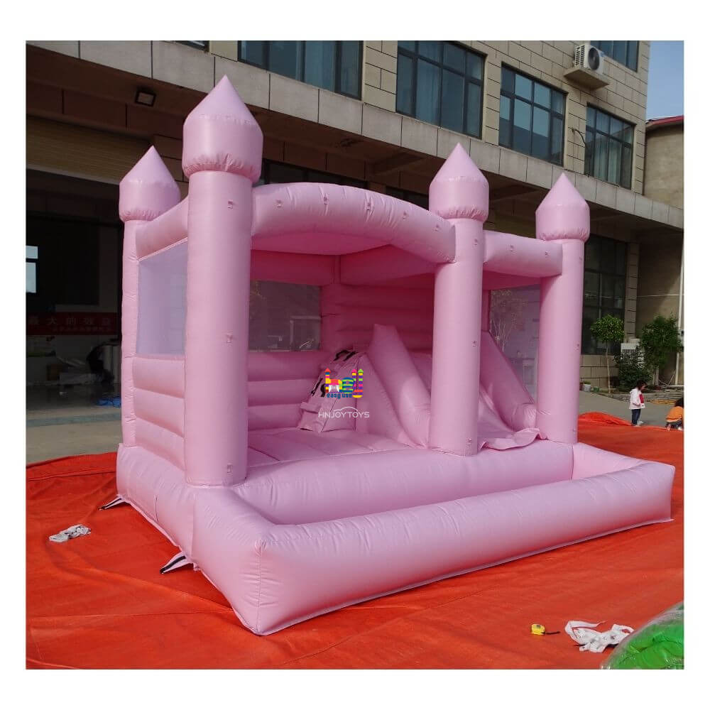 pastel pink bounce house with slide