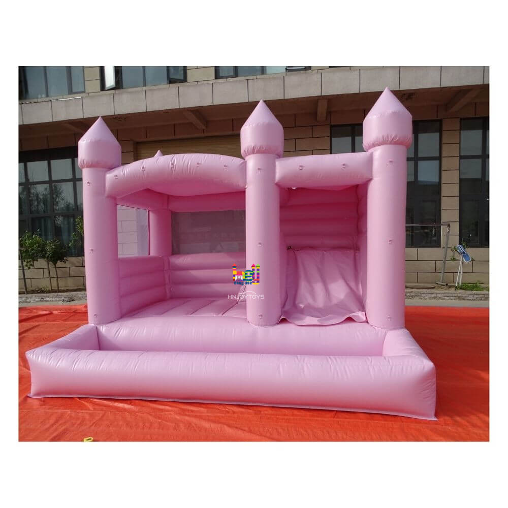 pastel pink bounce house with slide