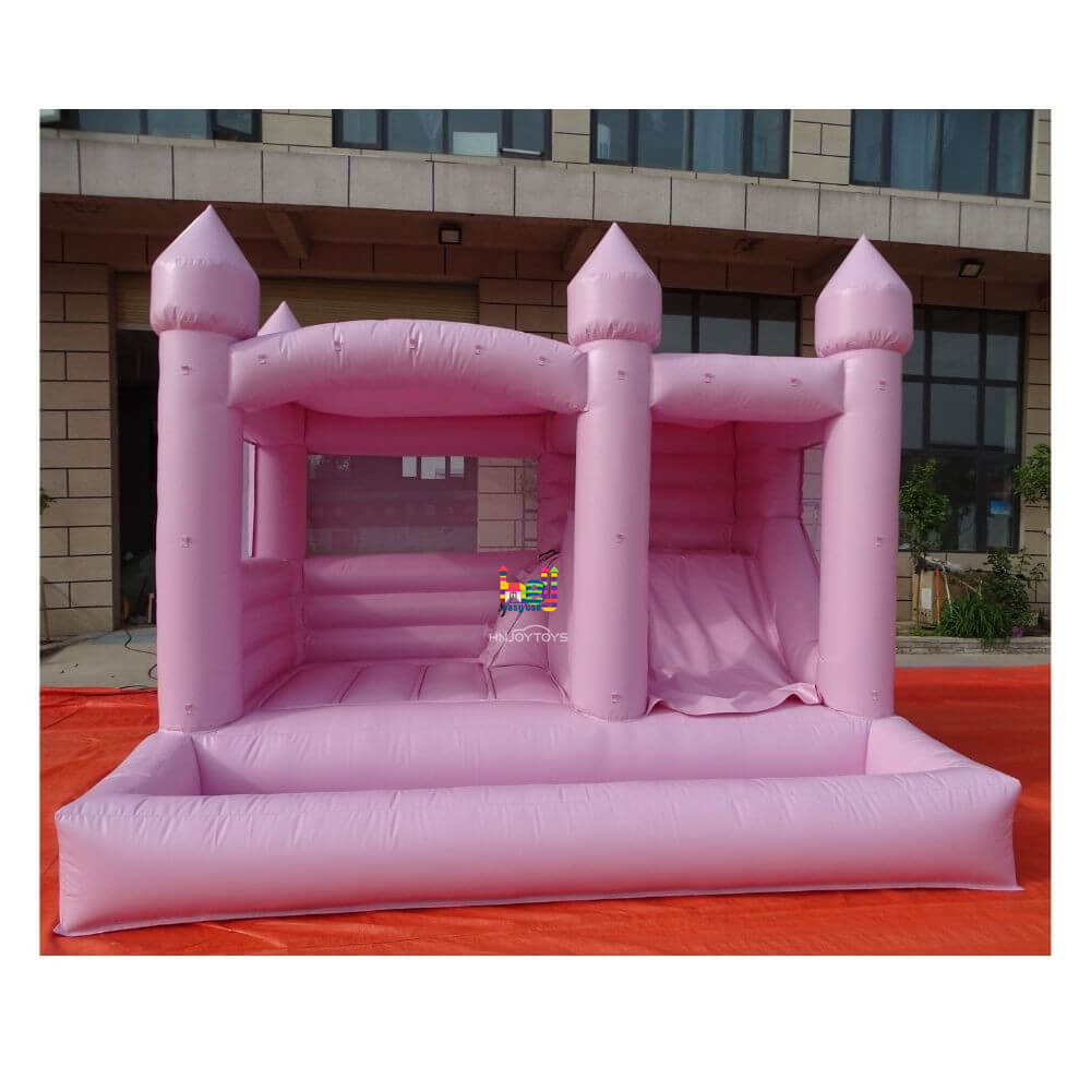 pastel pink bounce house with slide