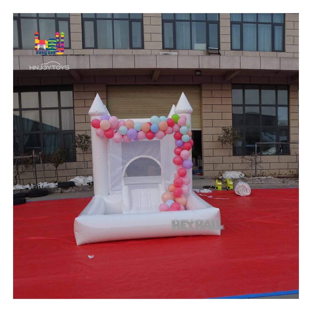 white bounce house with ball pit play with child