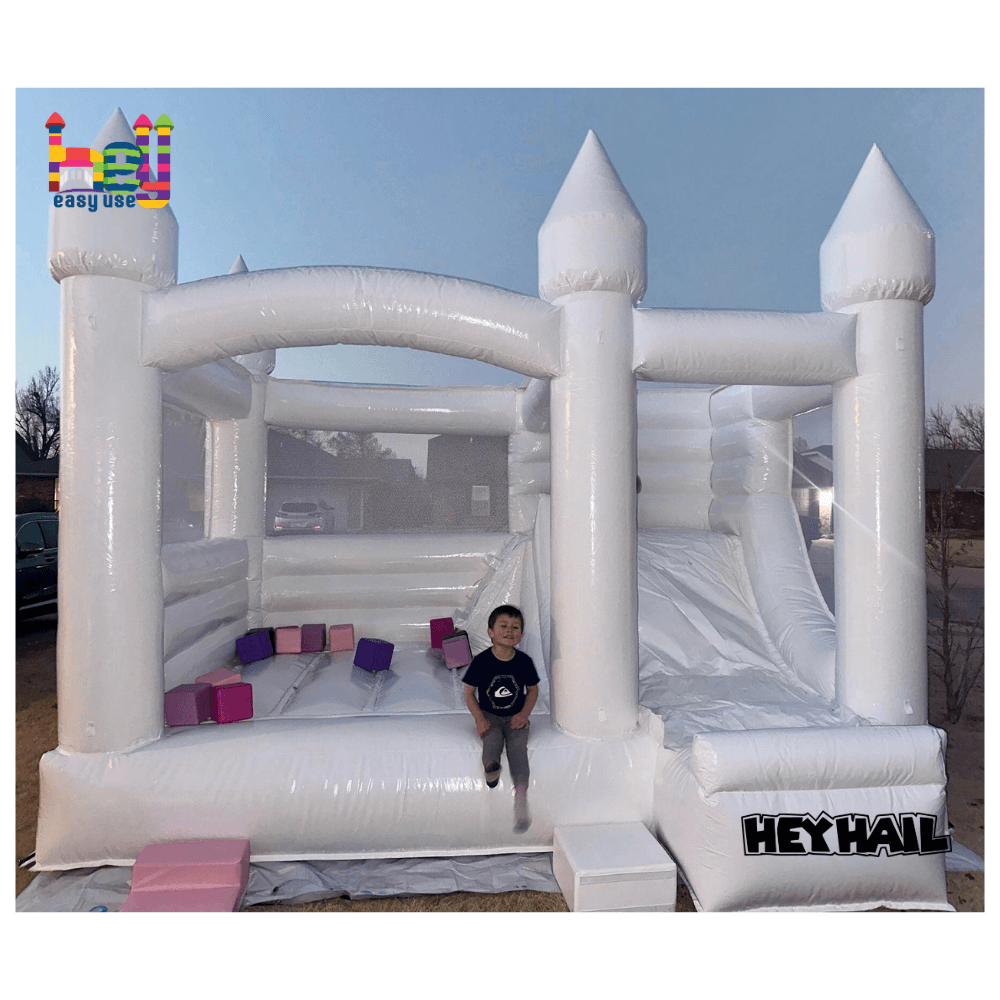 commercial white bounce house with balloons